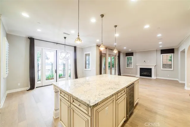 a kitchen with a stove a refrigerator a sink and a fireplace