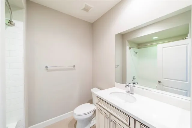 a bathroom with a sink toilet vanity and tub