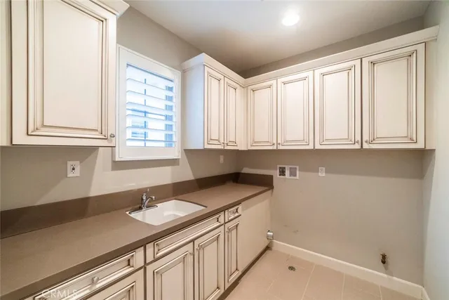 a kitchen with granite countertop a sink a stove and cabinets