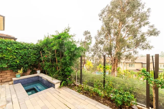 a view of backyard with swimming pool and outdoor seating
