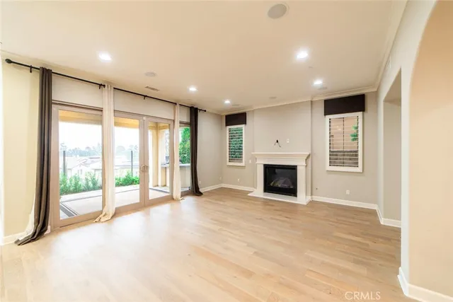a view of an empty room with a fireplace and a window