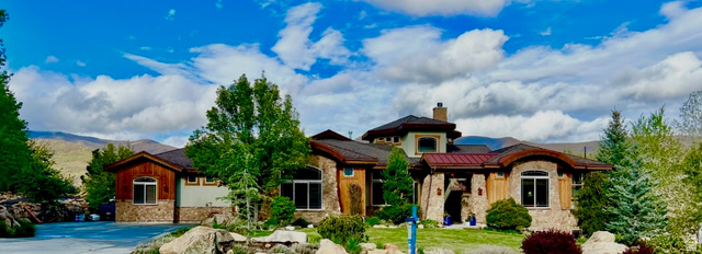 47 Meadow Drive Springville, UT 84663 - Photo 1 of 1 Custom stone and wood-sided architectural residence featuring multiple rooflines, arched windows, and a mature landscaped front yard with large boulders
