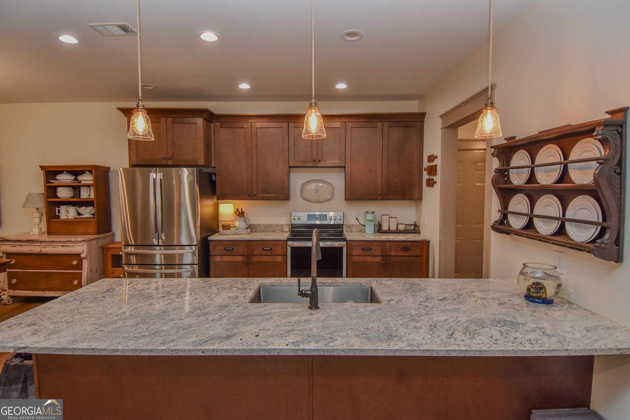 580-i B I B Howard Road Williamson, GA 30292 - Photo 17 of 123 a kitchen with kitchen island a counter top space cabinets and stainless steel appliances