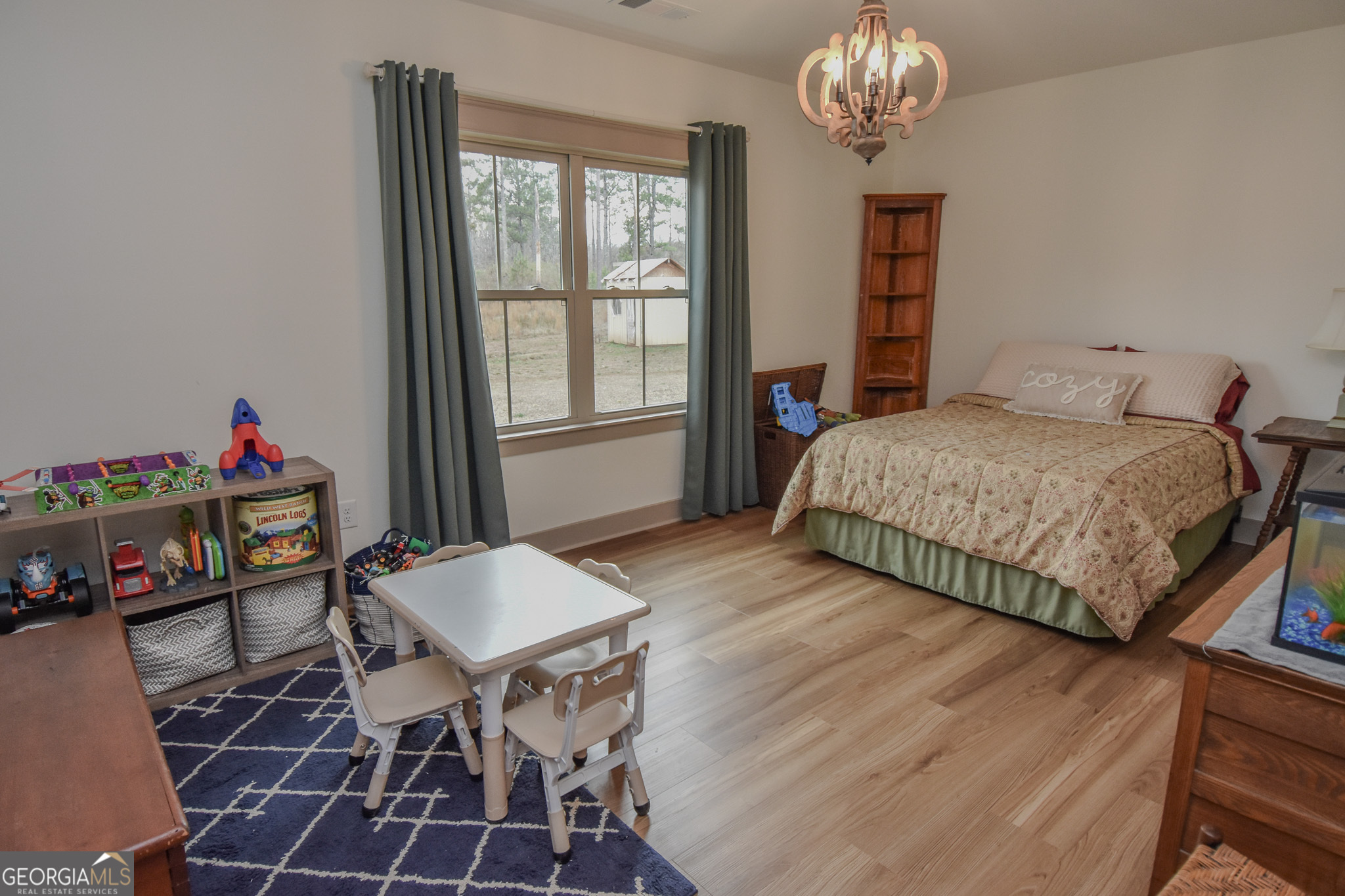 580-i B I B Howard Road Williamson, GA 30292 - Photo 27 of 123 a bedroom with a bed and a chandelier