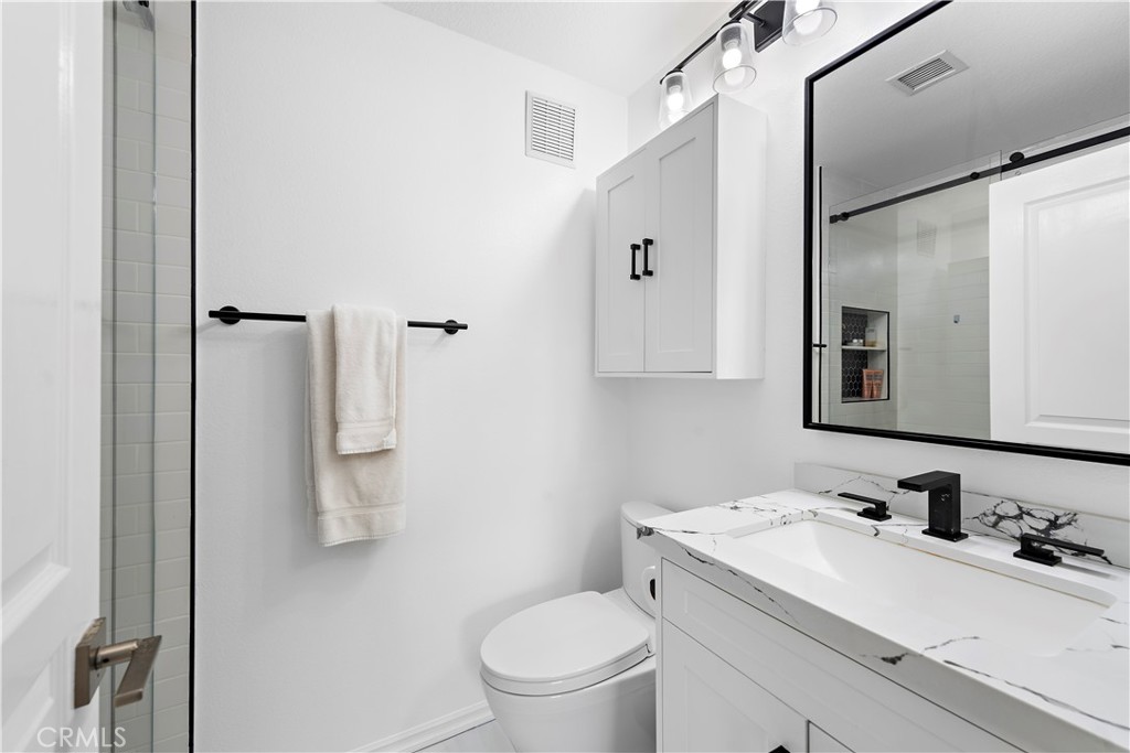 12 Triad Lane Ladera Ranch, CA 92694 - Photo 16 of 32 a bathroom with a granite countertop sink toilet and mirror