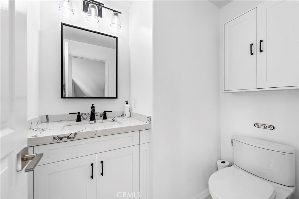 12 Triad Lane Ladera Ranch, CA 92694 - Photo 19 of 32 a bathroom with a toilet sink and mirror