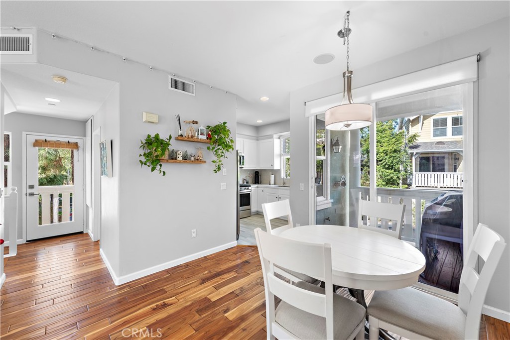 12 Triad Lane Ladera Ranch, CA 92694 - Photo 10 of 32 a view of a dining room with furniture window and wooden floor