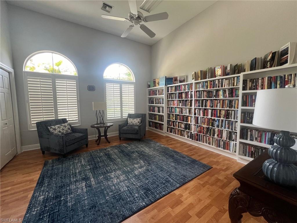 817 Regency Reserve Circle, Unit 3901 Naples, FL 34119 - Photo 27 of 34 Library/Sitting room featuring a towering ceiling and wood-type flooring