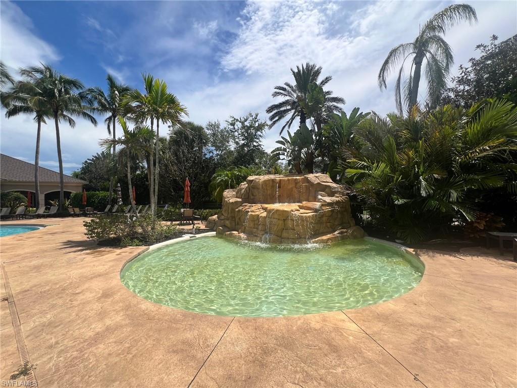 817 Regency Reserve Circle, Unit 3901 Naples, FL 34119 - Photo 35 of 35 View of pool with a patio and pool water feature