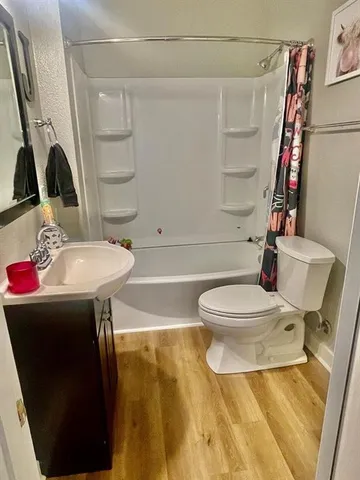a spacious bathroom with a granite countertop sink and a mirror