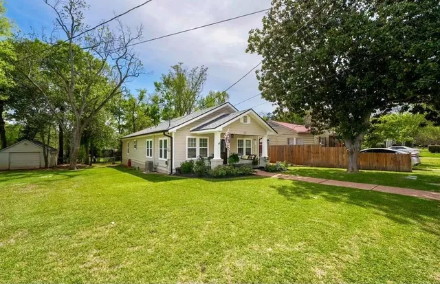 a front view of a house with yard and green space