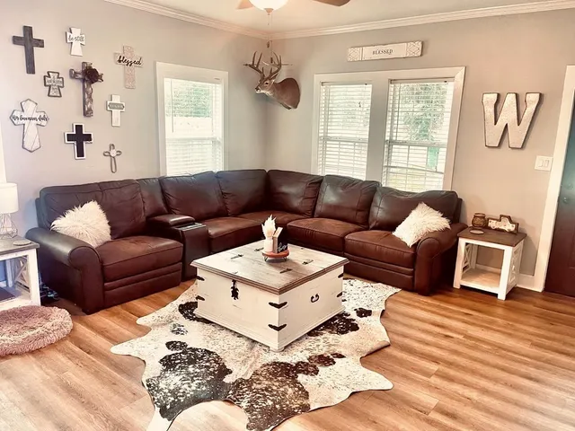 a living room with furniture window and wooden floor