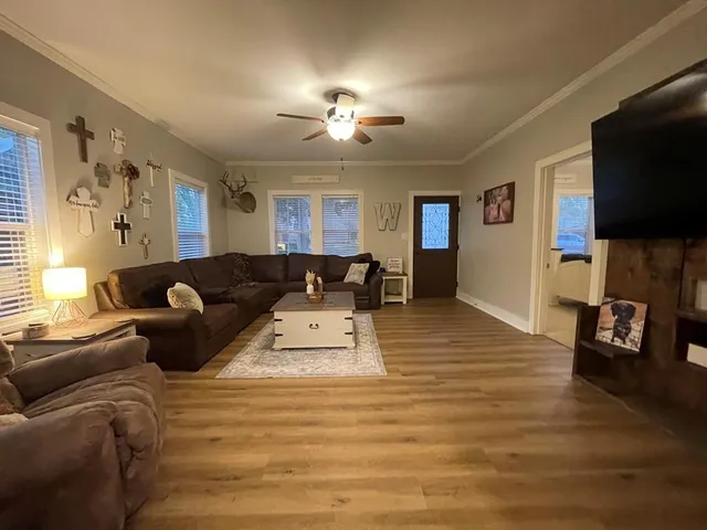 a living room with furniture and a flat screen tv