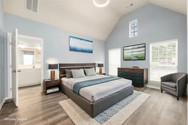 a bedroom with a large bed and potted plant