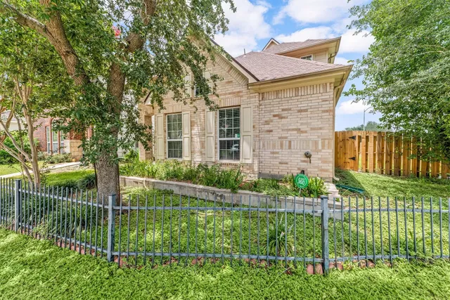 a view of a house with a small yard and plants