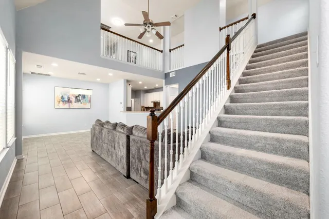 a living room with furniture flat screen tv and a window