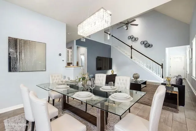 a living room with furniture and a large window with garden view