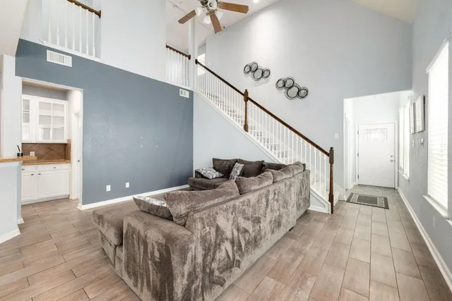 a view of a hallway with a white walls and a window