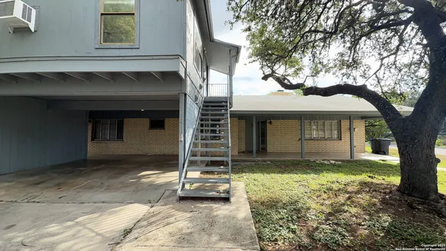 a view of a house with a tree in the background