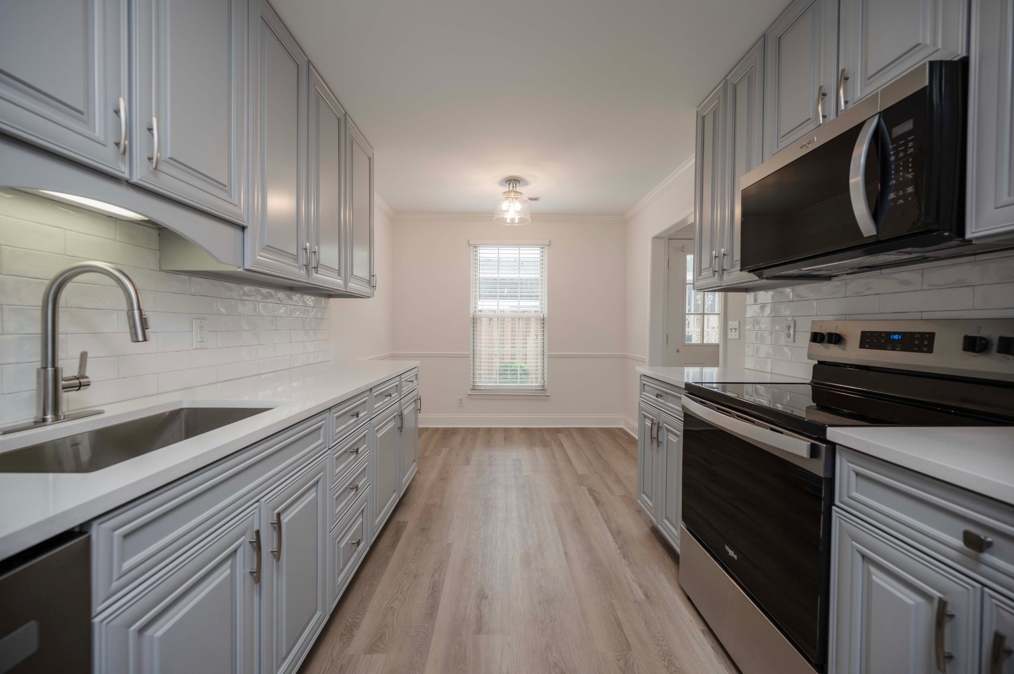 973 General George Patton Road Nashville, TN 37221 - Photo 7 of 15 a kitchen with stainless steel appliances a stove microwave and sink