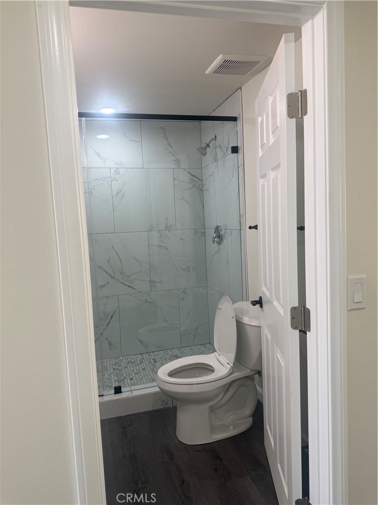 10337 Mull Avenue Riverside, CA 92505 - Photo 22 of 28 a white toilet sitting next to a bathroom sink