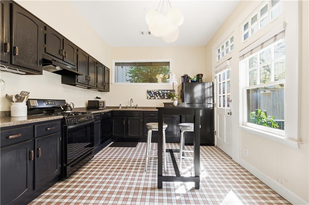 356 5th Street Northeast Atlanta, GA 30308 - Photo 11 of 54 a kitchen with stainless steel appliances granite countertop a stove a sink and a microwave