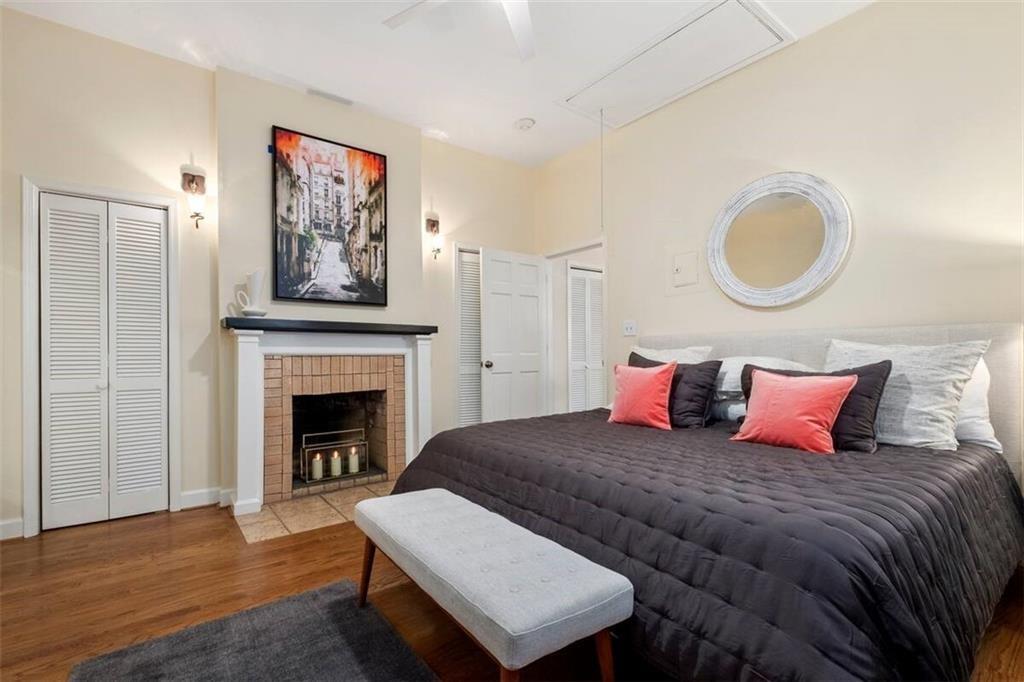 356 5th Street Northeast Atlanta, GA 30308 - Photo 15 of 54 a bedroom with a bed and a fireplace