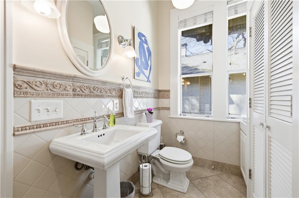 356 5th Street Northeast Atlanta, GA 30308 - Photo 18 of 54 a bathroom with a sink a mirror and a toilet