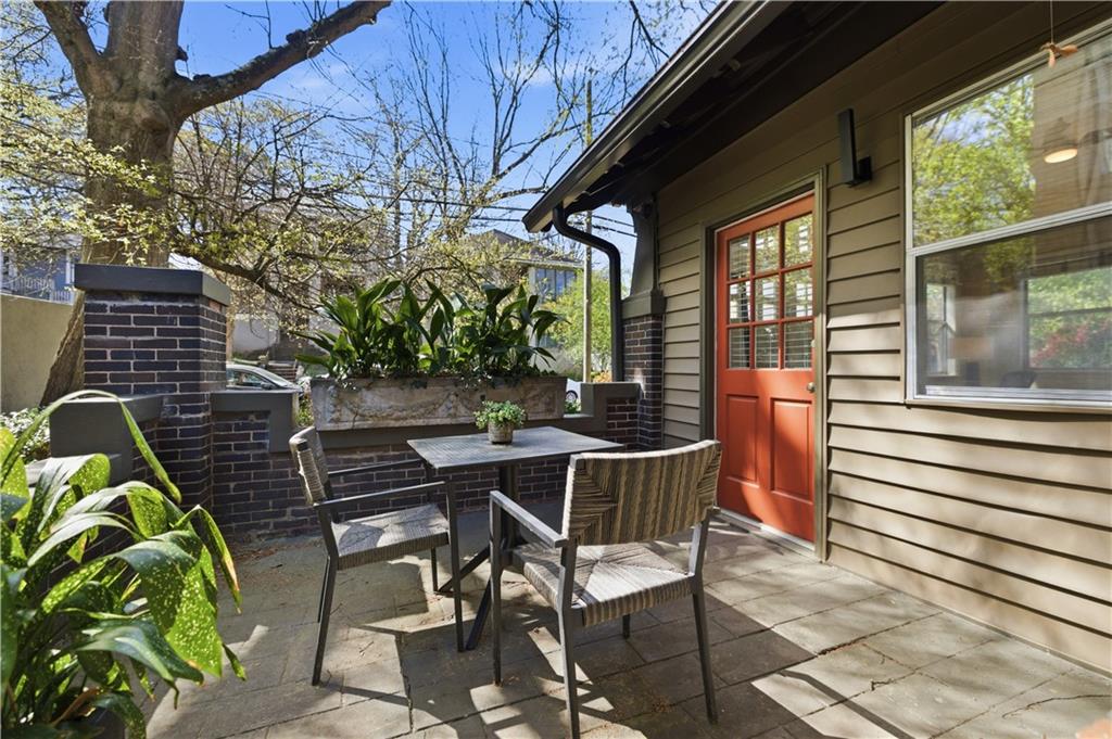 356 5th Street Northeast Atlanta, GA 30308 - Photo 21 of 54 a view of a patio with a table and chairs and potted plants