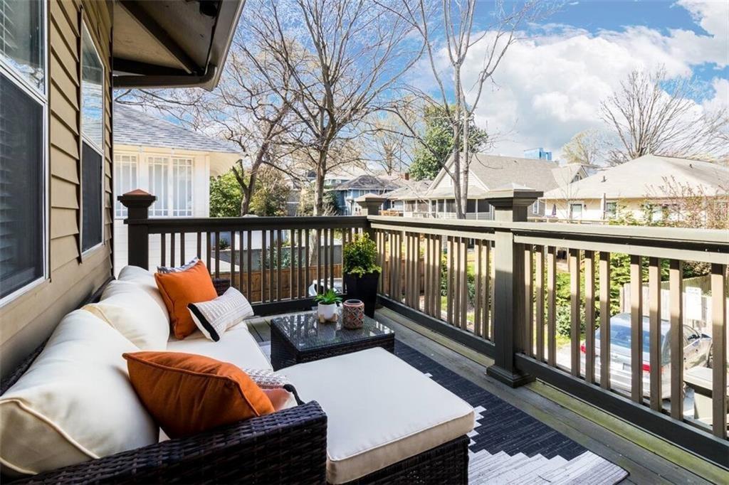 356 5th Street Northeast Atlanta, GA 30308 - Photo 23 of 54 a balcony with wooden floor and outdoor seating