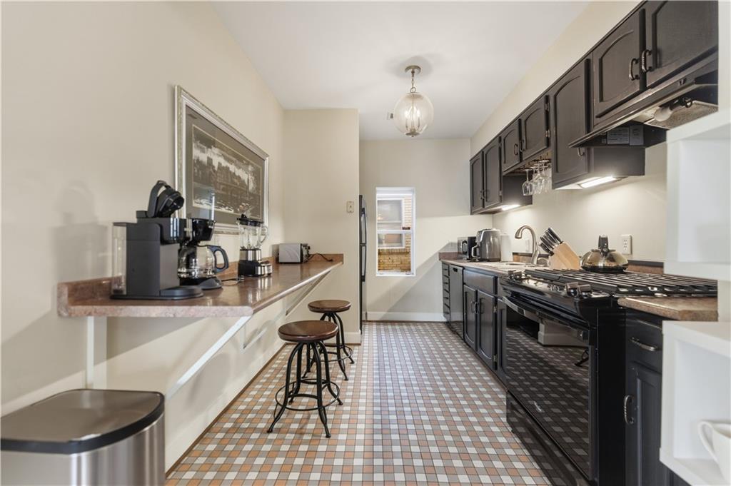 356 5th Street Northeast Atlanta, GA 30308 - Photo 41 of 54 a kitchen with stainless steel appliances granite countertop a sink a stove and a refrigerator