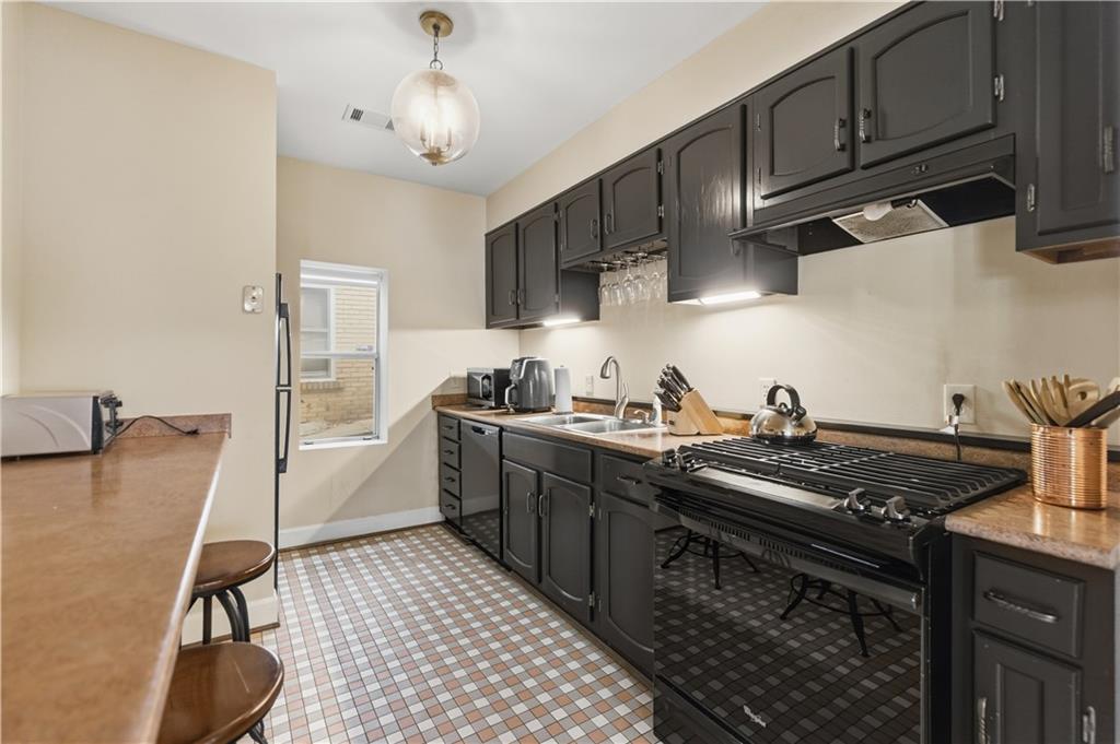 356 5th Street Northeast Atlanta, GA 30308 - Photo 42 of 54 a kitchen with granite countertop a stove and a sink