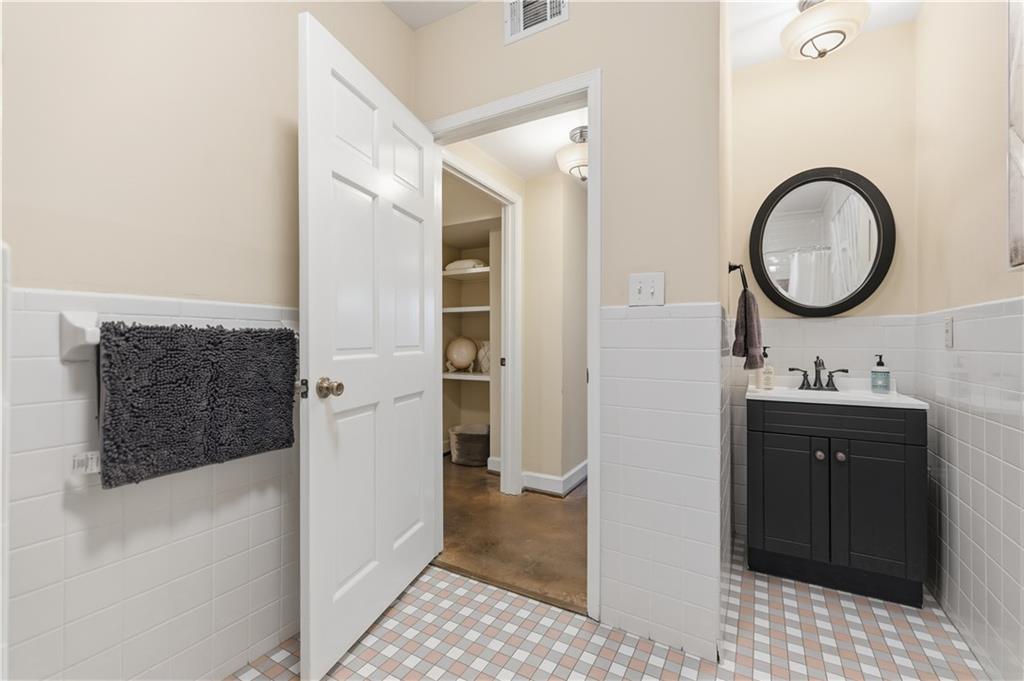 356 5th Street Northeast Atlanta, GA 30308 - Photo 47 of 54 a bathroom with a sink and a mirror