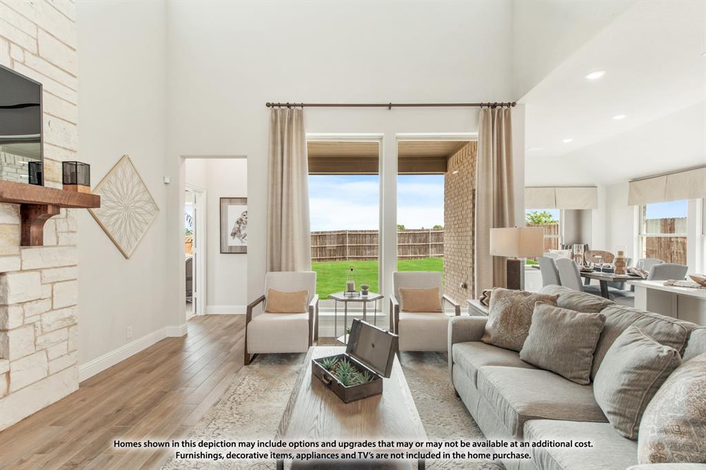 1108 Edgemire Lane Aubrey, TX 76227 - Photo 11 of 34 a living room with furniture and a large window with garden view