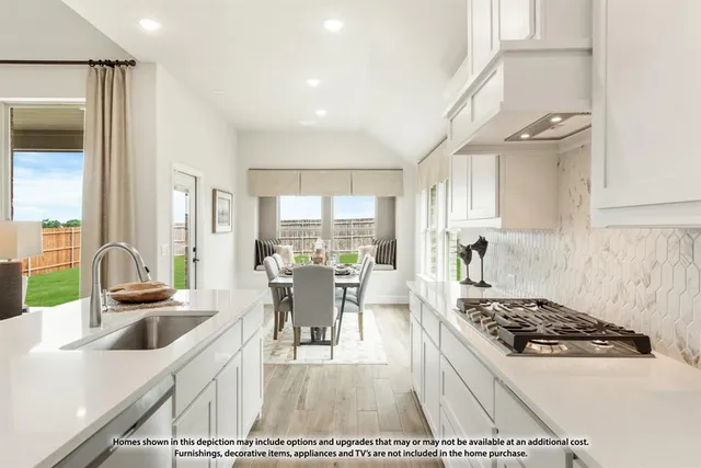 a kitchen with a stove a sink and a dining table