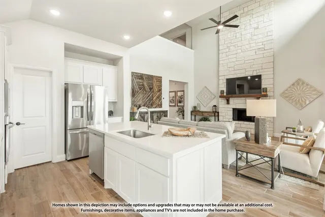 a view of living room with stainless steel appliances granite countertop furniture and a fireplace