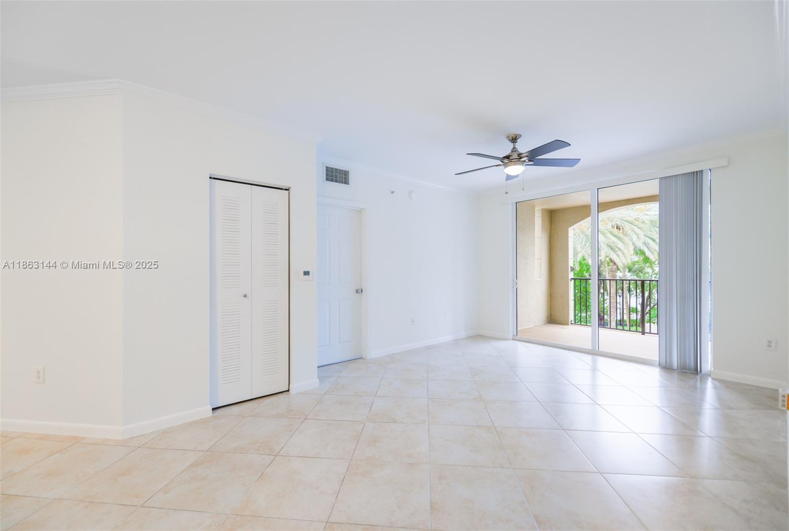 17100 North Bay Road, Unit 1303 Sunny Isles Beach, FL 33160 - Photo 12 of 24 a view of a livingroom with a ceiling fan and window