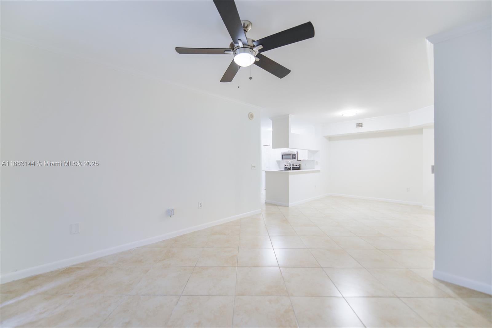 17100 North Bay Road, Unit 1303 Sunny Isles Beach, FL 33160 - Photo 14 of 24 a view of a kitchen with a sink and a ceiling fan