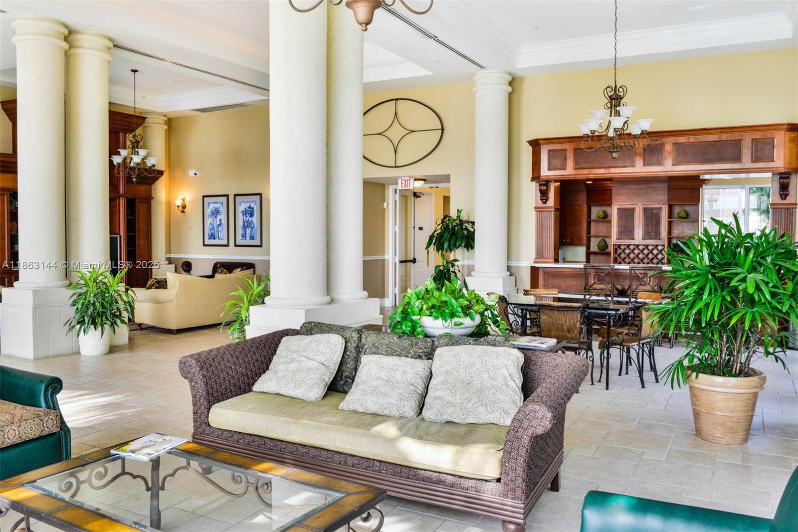 17100 North Bay Road, Unit 1303 Sunny Isles Beach, FL 33160 - Photo 19 of 24 a living room with furniture a potted plant and a chandelier