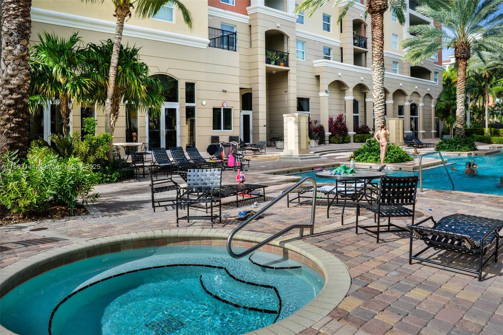 17100 North Bay Road, Unit 1303 Sunny Isles Beach, FL 33160 - Photo 22 of 24 a view of a patio with couches table and chairs potted plants and palm trees