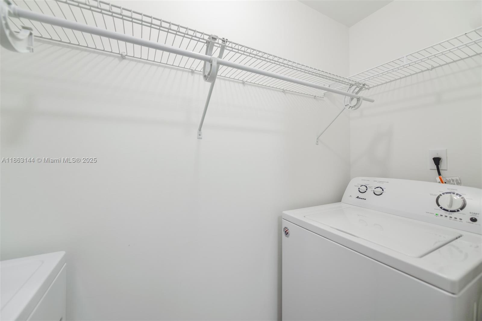 17100 North Bay Road, Unit 1303 Sunny Isles Beach, FL 33160 - Photo 7 of 24 a utility room with dryer and washer