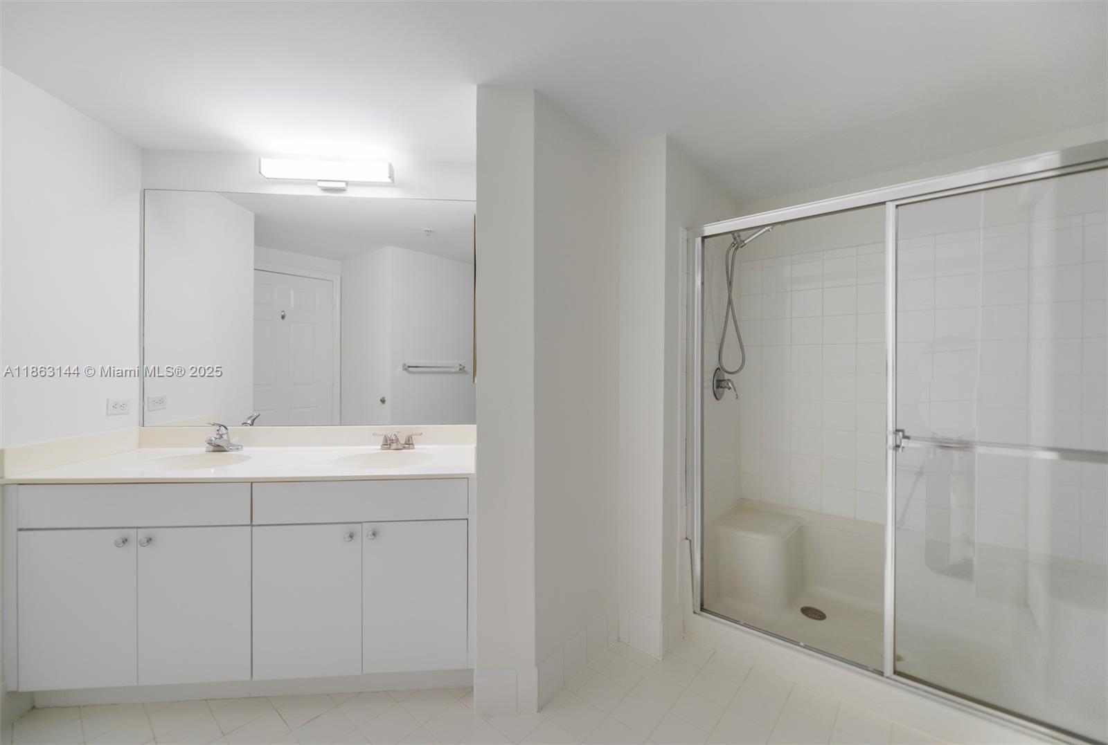 17100 North Bay Road, Unit 1303 Sunny Isles Beach, FL 33160 - Photo 10 of 24 a bathroom with a double vanity sink and mirror