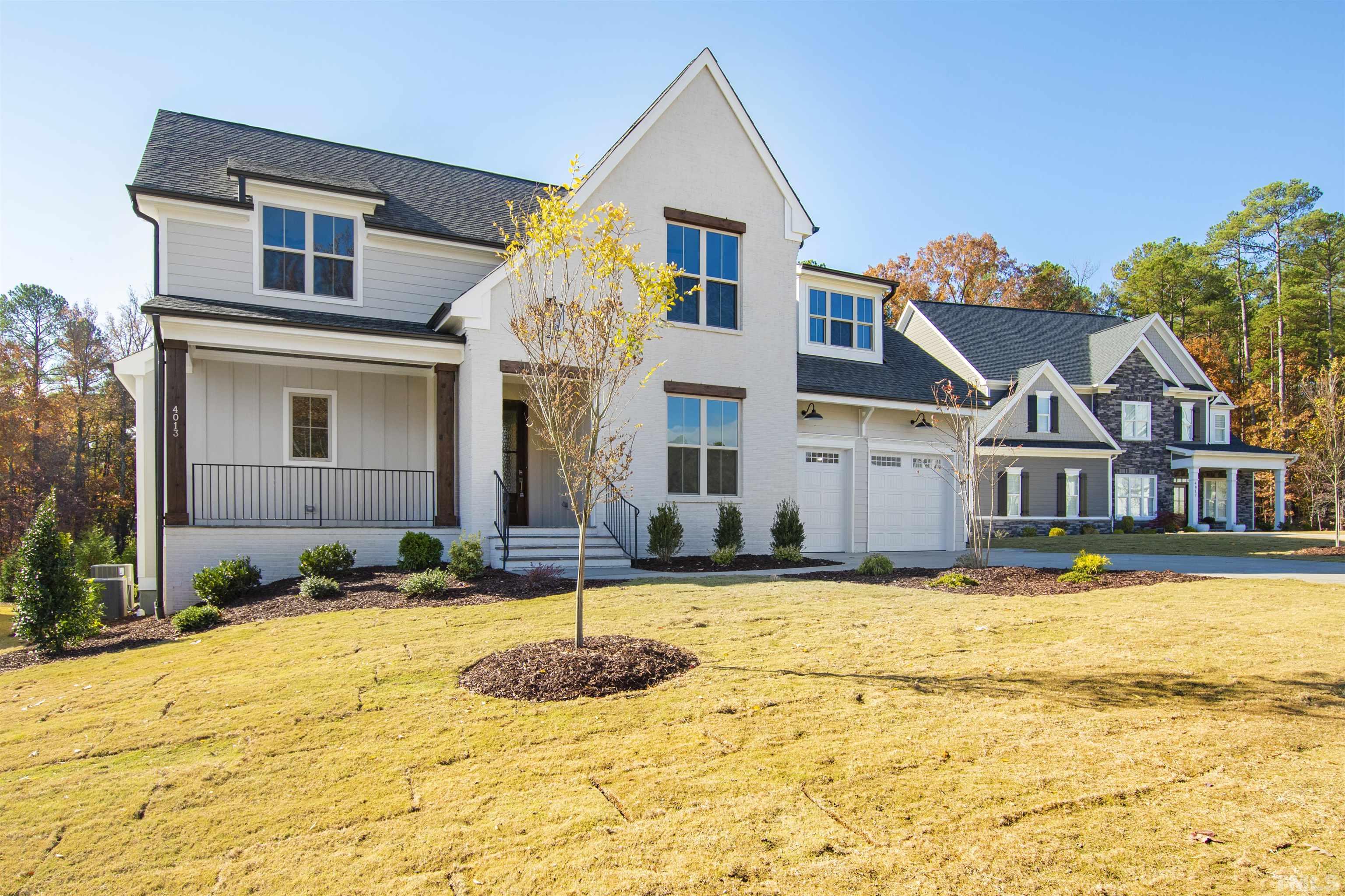 4013 Wilton Woods Place Cary, NC 27519 - Photo 1 of 30 a front view of a house with a yard