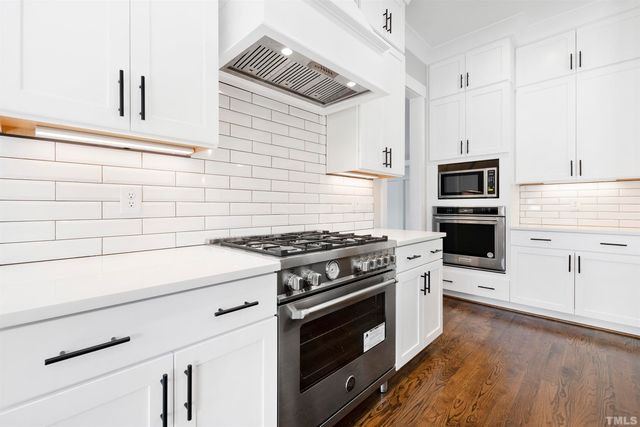 a kitchen with a stove and a microwave