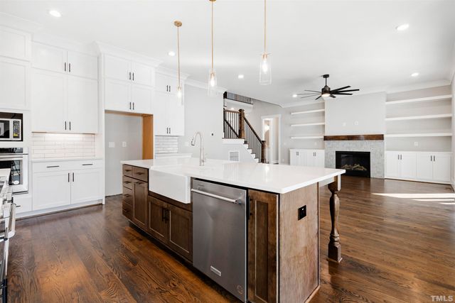a kitchen with cabinets and wooden floor