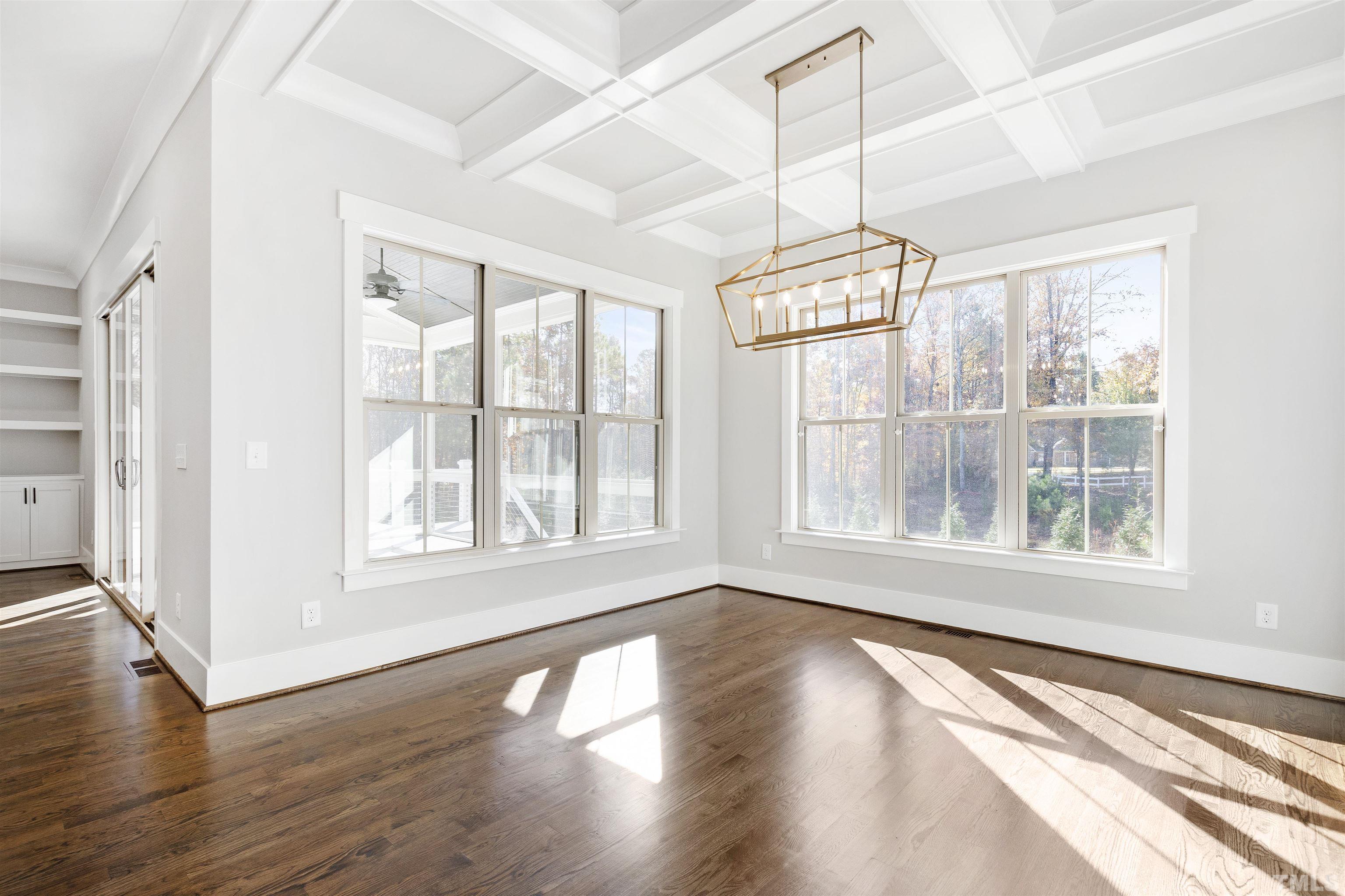 4013 Wilton Woods Place Cary, NC 27519 - Photo 19 of 30 a view of an empty room with wooden floor and a window
