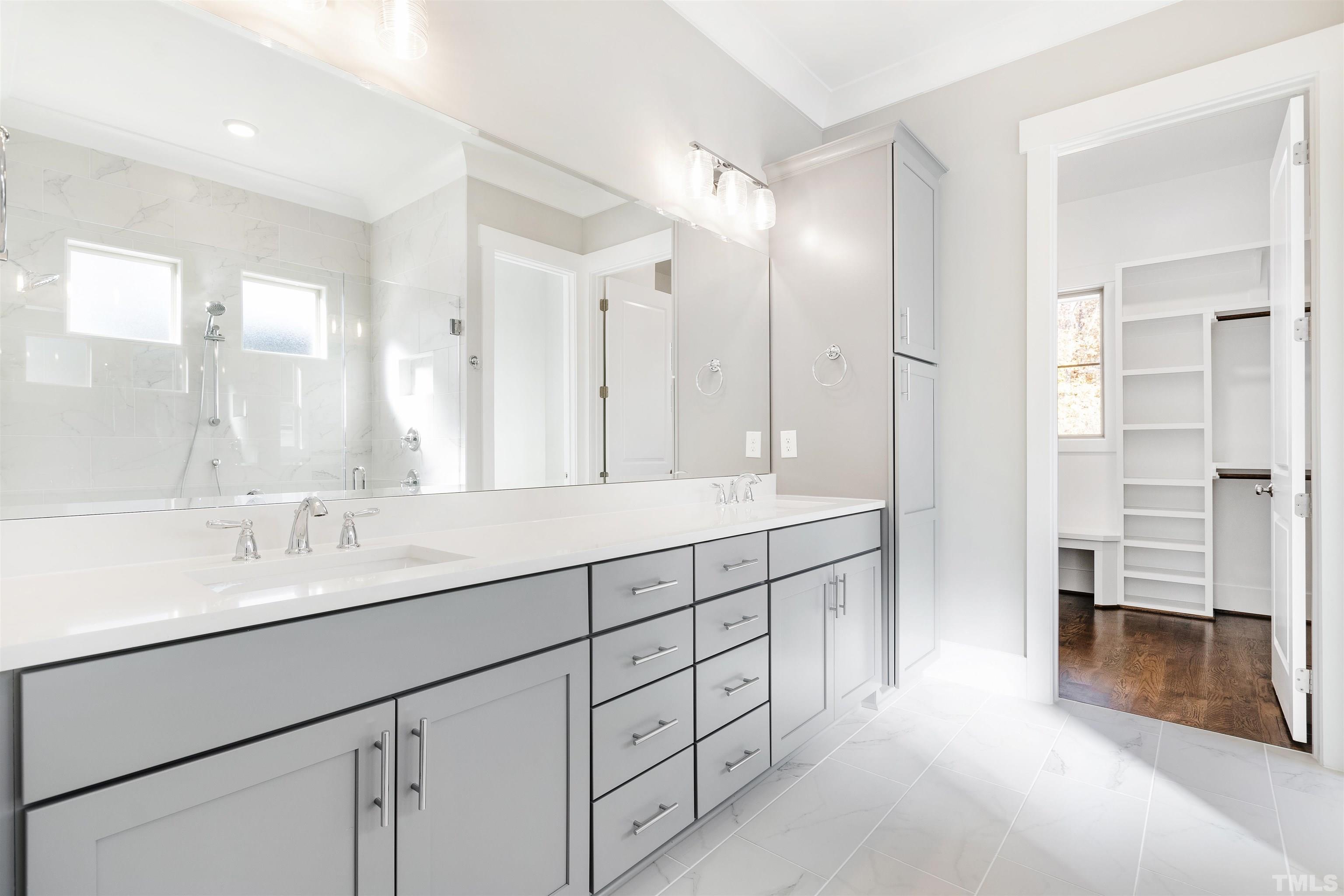 4013 Wilton Woods Place Cary, NC 27519 - Photo 23 of 30 a spacious bathroom with a shower sink and a mirror