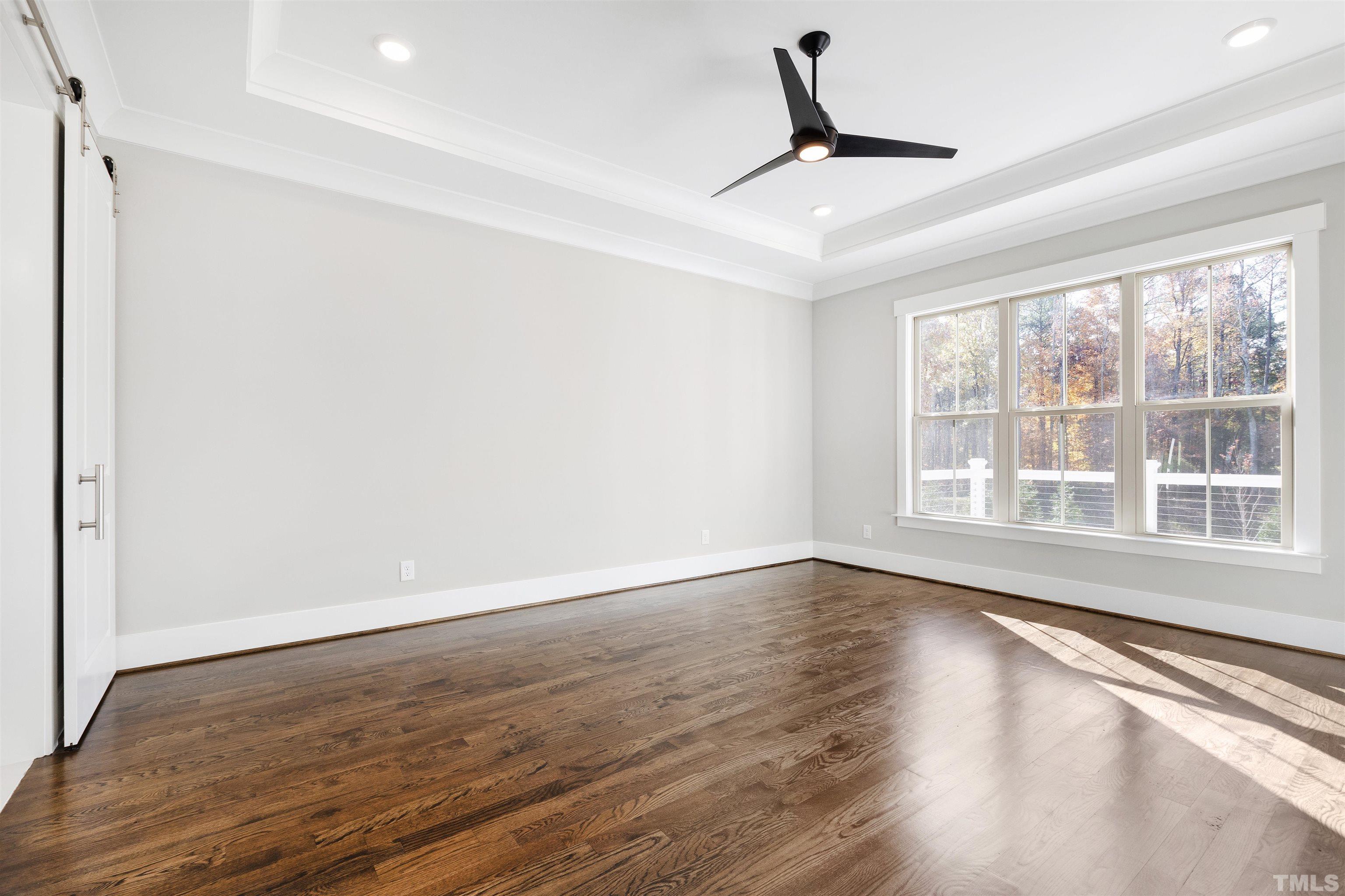 4013 Wilton Woods Place Cary, NC 27519 - Photo 4 of 30 wooden floor in an empty room with a window
