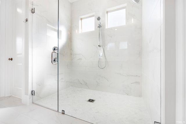 a bathroom with a glass shower door