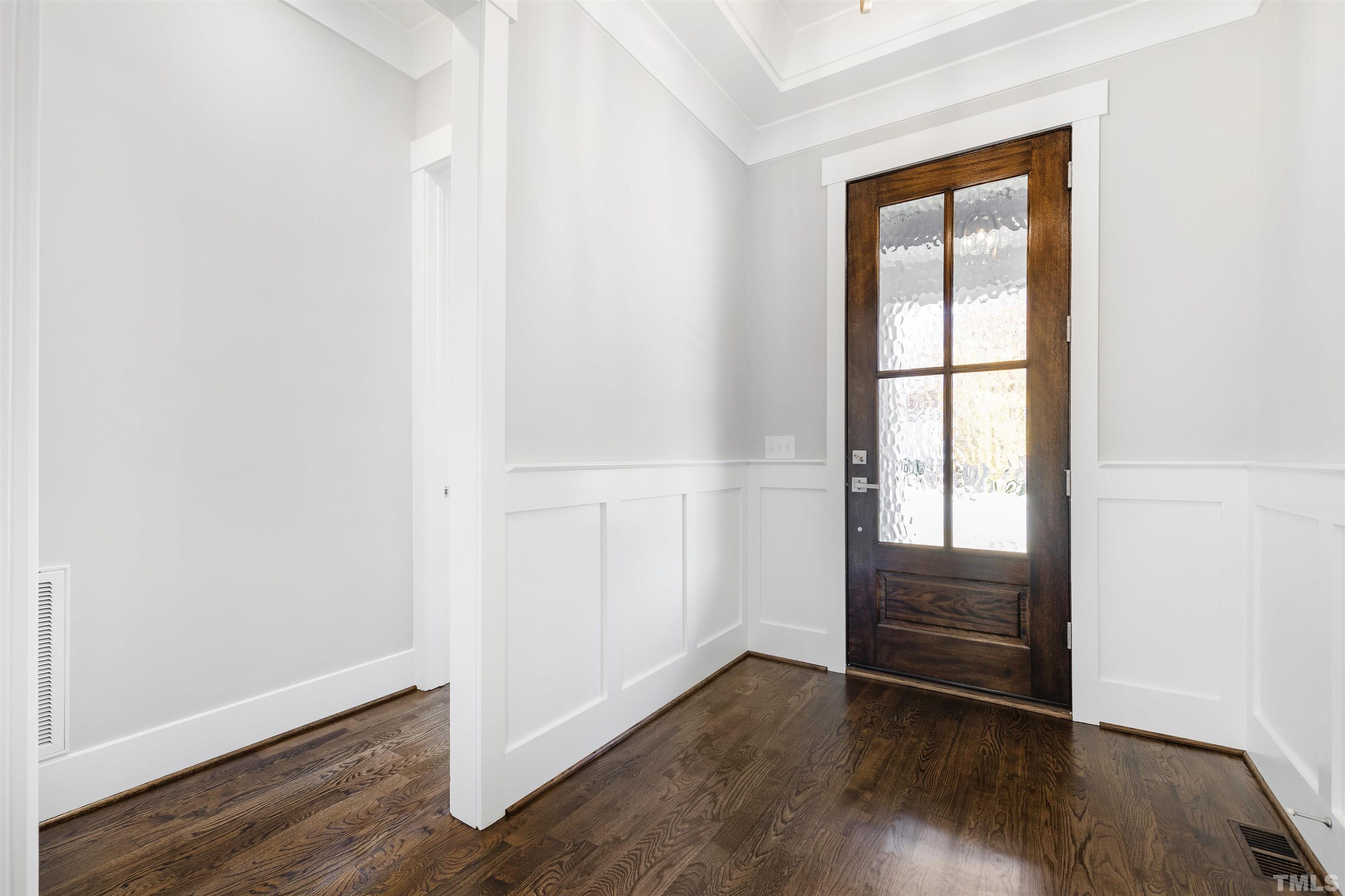 4013 Wilton Woods Place Cary, NC 27519 - Photo 6 of 30 an empty room with wooden floor and windows